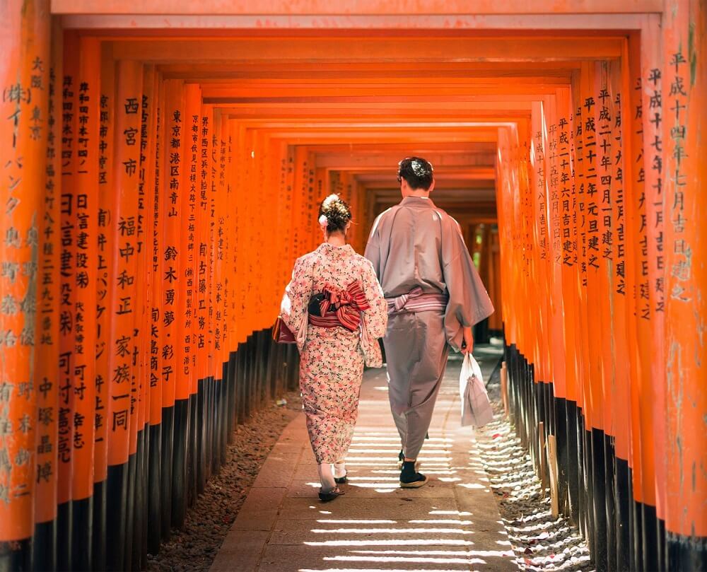 Couple at Kyoto's Fushimi Inari Taisha Shrine - 20 Best Honeymoon Destinations for 2023