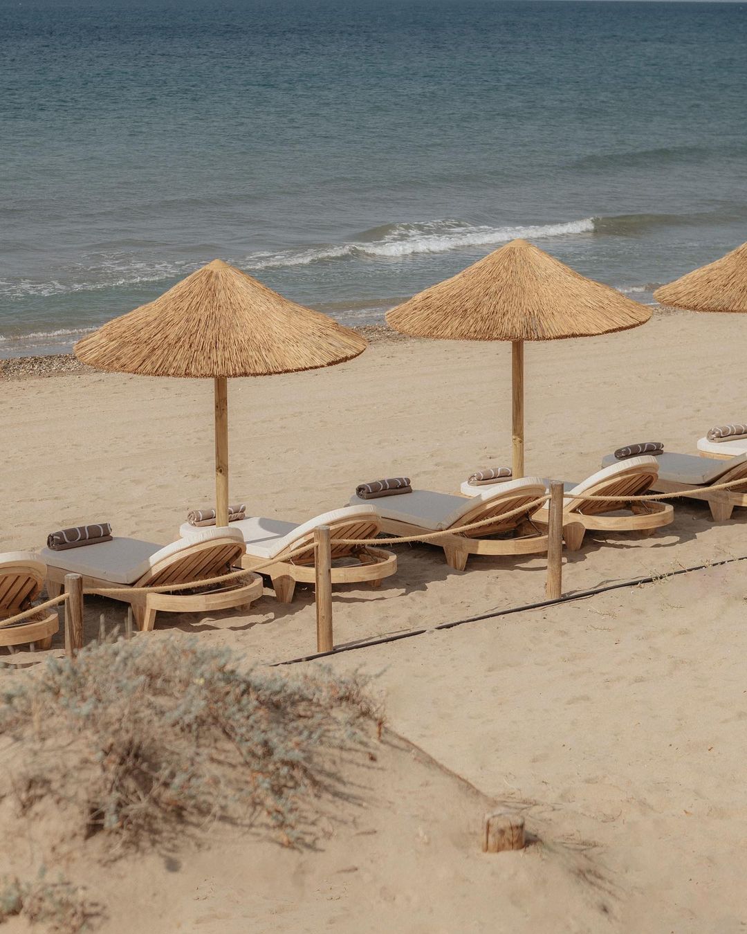 Gorgeous rustic sunbeds on the beach at Dune Beach Marbella