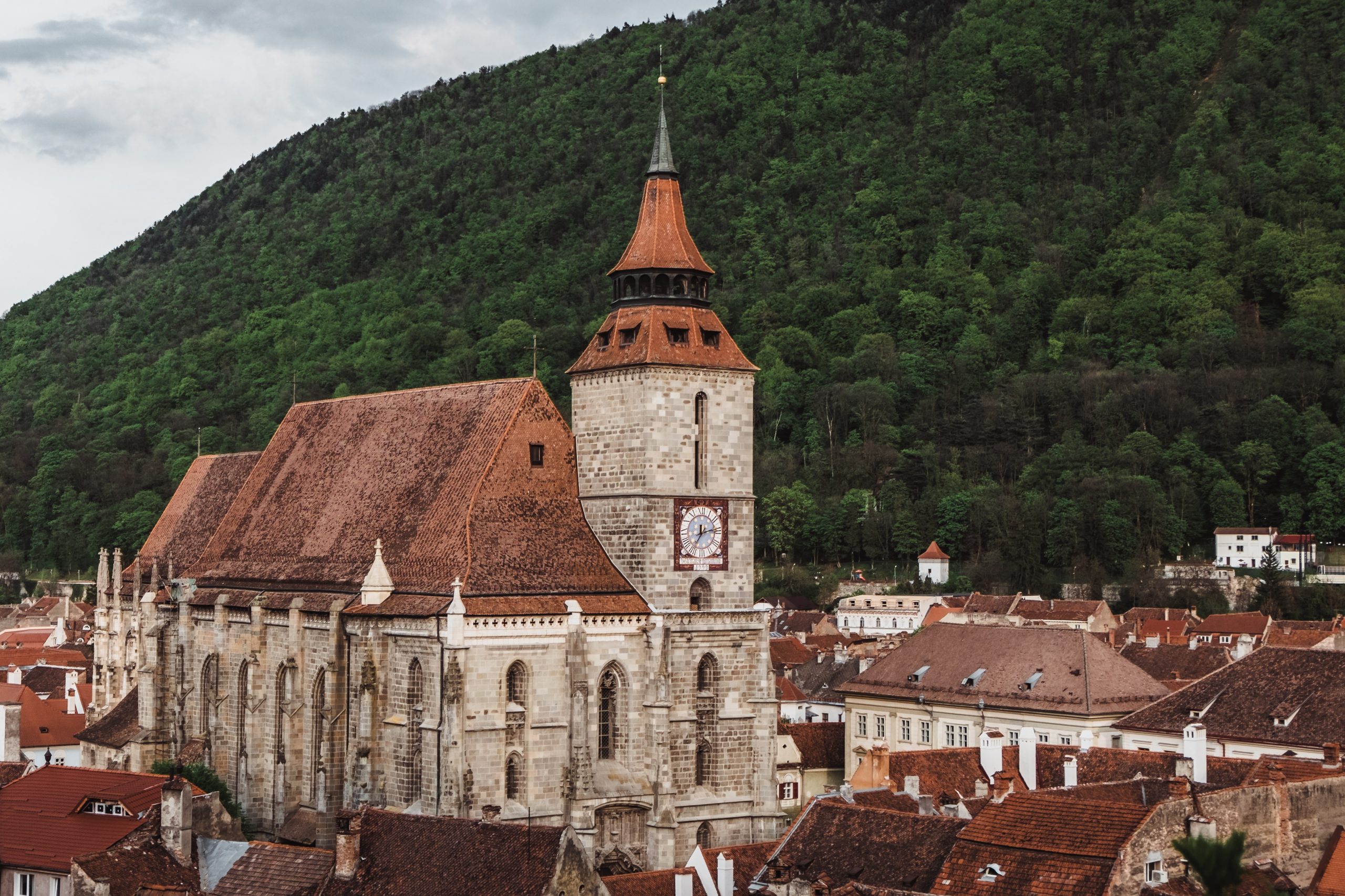 The imposing gothic Black Church of Brasov with Mount Tampa in the Background - Transylvania - Interesting Facts To Know