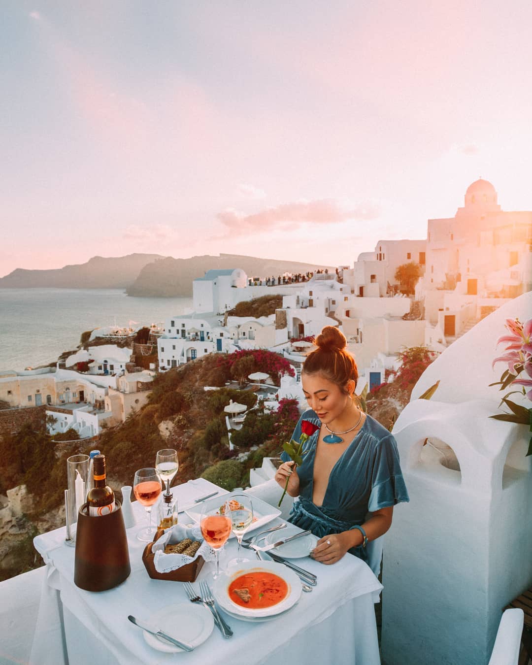 "Couldn't think of better way to enjoy the sunset in Santorini than with dinner and rosé. 🍷"