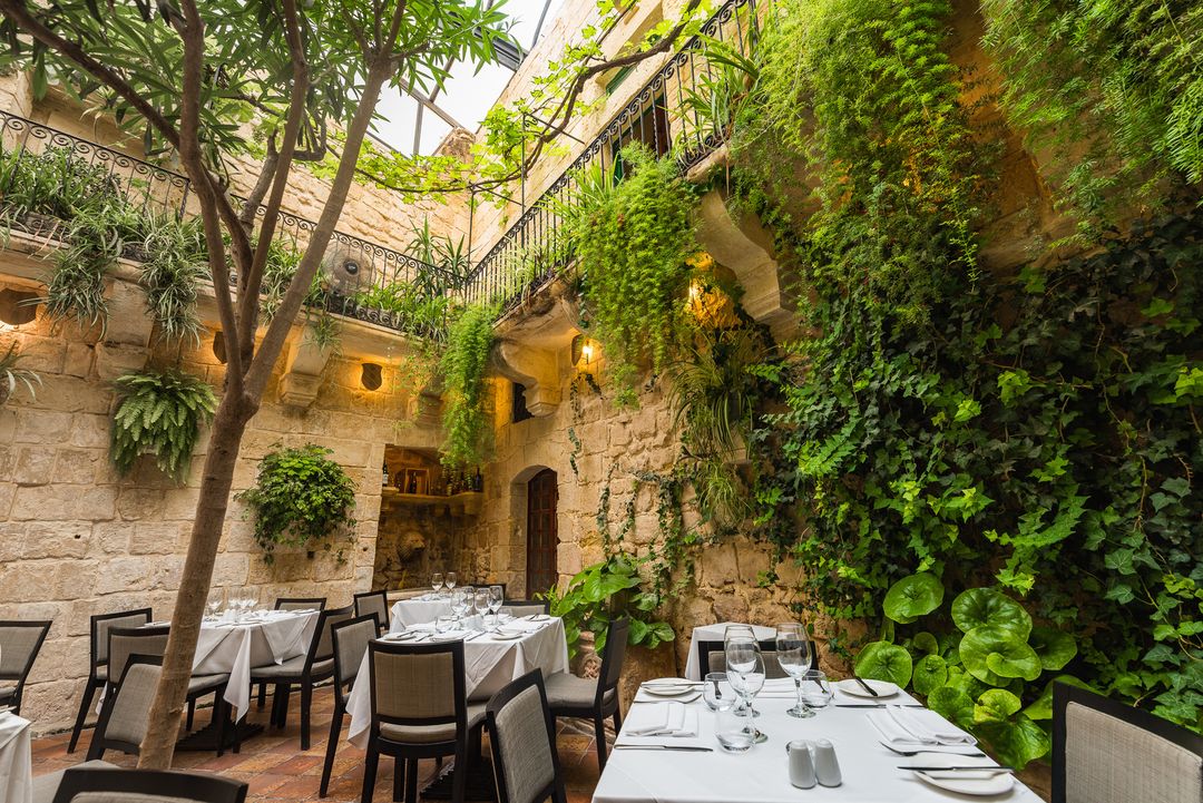 How enchanting is this courtyard at Medina restaurant Malta? Best Outdoor Restaurants in Europe